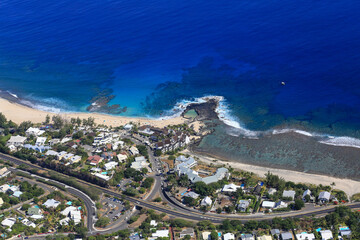 Cristalline blue lagoon waters of West Reunion island and white sand beach