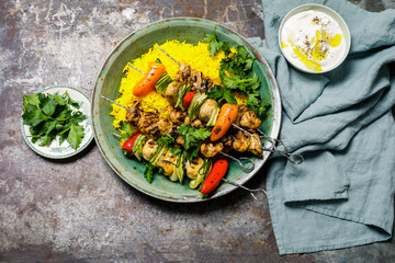 chicken shashlik on yellow rice with yoghurt dip