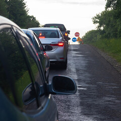 traffic jams on the road are associated with the repair of the roadway. evening