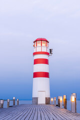 Wooden Pier with Lighthouse in Podersdorf on Lake Neusiedler in Austria at Sunrise.