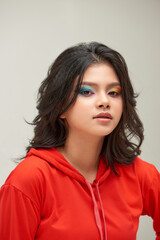 Fototapeta premium Portrait of young woman with funny rainbow colored make-up