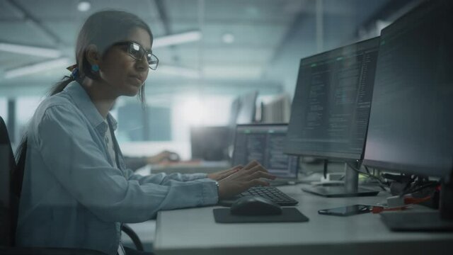 Diverse Office: Enthusiastic Indian IT Programmer Working on Desktop Computer. Female Specialist Creating Innovative Software. Engineer Developing App, Program, Video Game. Writing Code in Terminal
