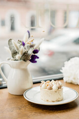 Beautiful delicious dessert on the table. Enjoy a freshly baked dessert in a coffee shop, restaurant. A closeup shot of a little sweet decorative cake. Soft selective focus.