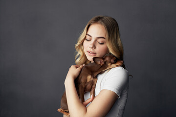 Fototapeta premium woman a small dog fun Studio isolated background