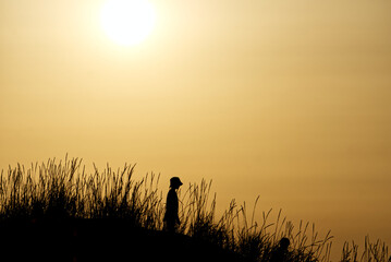 silhouette of a child at sunset