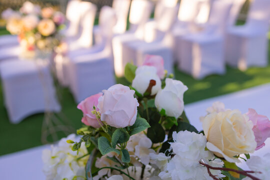 White Chairs With Pink Bows For Wedding Exit Registration.