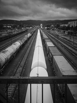 Black and White High-Angle View of Freight Tank Cars on Parallel Railway Tracks