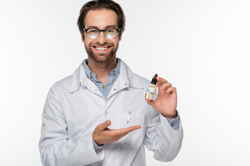 happy physician pointing at vial with hemp oil isolated on white