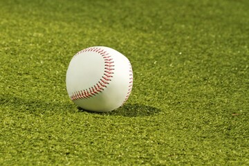 Baseball on neatly mowed grass