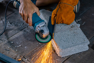 Chanthaburi, Thailand, August 23, 2021: Close up of a worker cutting steel, Sparks from cutting...