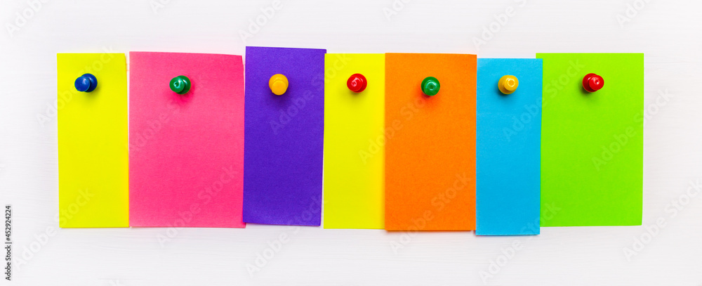 Aufkleber on a white background, bright multi-colored strips of paper with a place to insert text are fixed wi