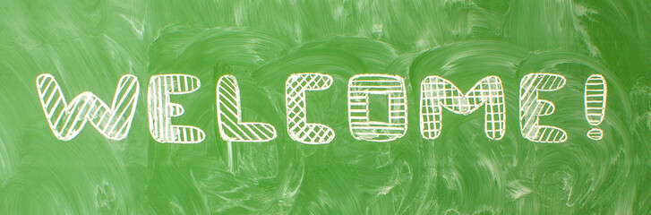 The inscription in English is welcome, written in handwritten font on a green school blackboard with traces of chalk and space for copying. Concept - back to school