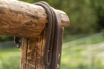 Close-up of lead ropes hanging over a hitching post