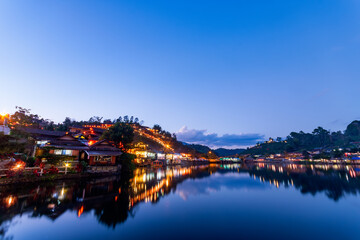 beautiful sunsets view of Ban rak thai, Mae Hong Son, Thailand. The dusk scene after sunset with the reflection of the buildings and night market 