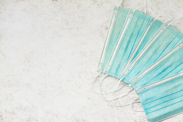 Blue Surgical Masks on a Marble Background with Copy Space