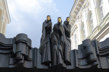three statues with the golden mask in vilnius - 452927203