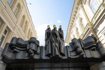 three statues with the golden mask in vilnius - obrazy, fototapety, plakaty