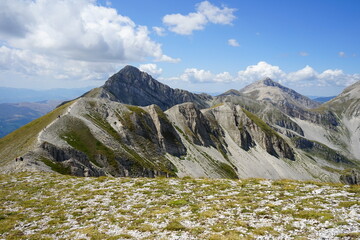 People walking on the mountain ridge over Mount Aquila in Gran Sasso National Park, Campo...