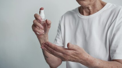 Old Woman Apply Sanitizer Spray on Hands for Cleaning Bacterium. Person Washing Cleanliness Antibacterial Sprayer. Concept Purity and Hygiene in Quarantine. Spraying Particle Human Close-up Indoors - Powered by Adobe