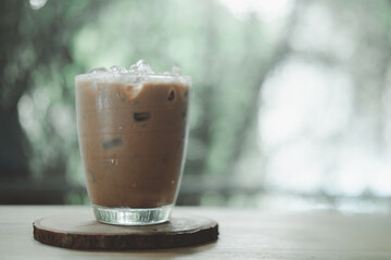 A glass of iced mocha on wooden table. Cold summer drink
