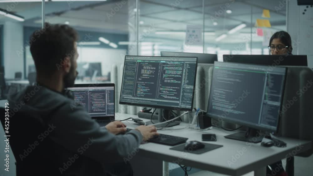 Fototapete Diverse Office: IT Programmer Working on Desktop Computer. Male Specialist Creating Innovative Software Engineer Developing App, Program, Video Game. Terminal with Coding Language. Over Shoulder