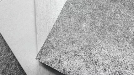 Zelfklevend Fotobehang close up concrete ceramic tile sample swatch showing multi texture of tile in grey color tone. stone tile samples in macro view. grained granite tile catalog. © WONGSAKORN