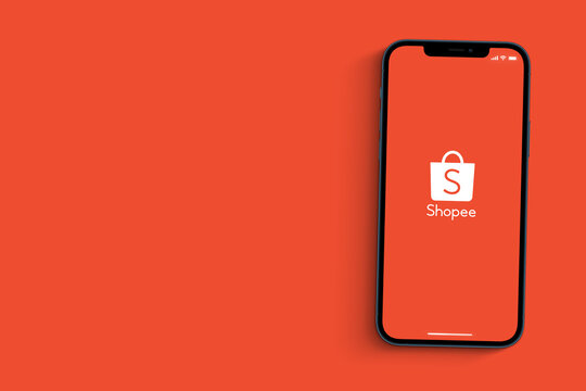 Shopee app on the smartphone screen isolated on orange background. Top view. Rio de Janeiro, RJ, Brazil. August 2021.