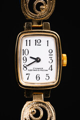 Golden watch on black background - made in Russia
