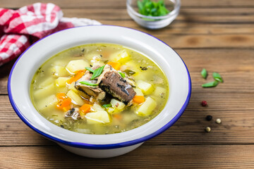 Low calorie vegetable fish soup on wooden rustic background. Space for text.