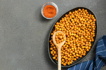 Crispy smoked paprika chickpeas in cast iron skillet on dark background. Top view, copy space.