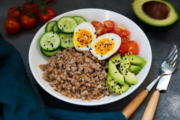 Buddha bowl with vegetables, buckwheat tomatoes and avocado