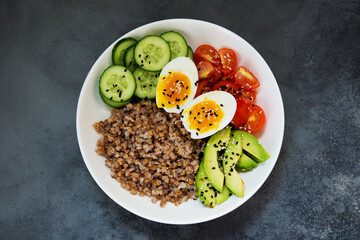 Buddha bowl with vegetables, buckwheat tomatoes and avocado, healthy food