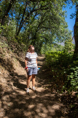 Fototapeta na wymiar Woman Hiking a Forest Trail in the California Mountains