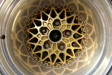 The detail of a wheel of an old rallye car with part of the rim with interesting design 