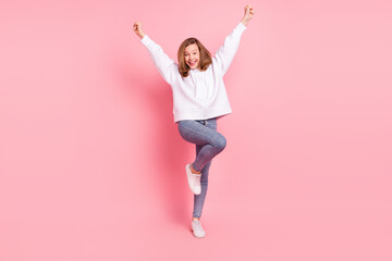 Full length body size view of attractive cheerful girl dancing having fun rejoicing isolated over pink pastel color background