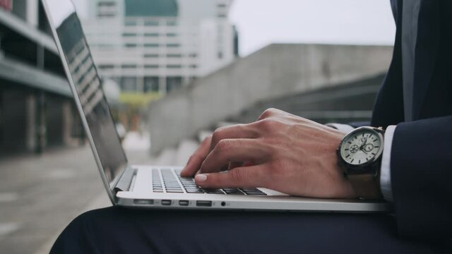 4k footage of an unrecognised businessman typing on his laptop