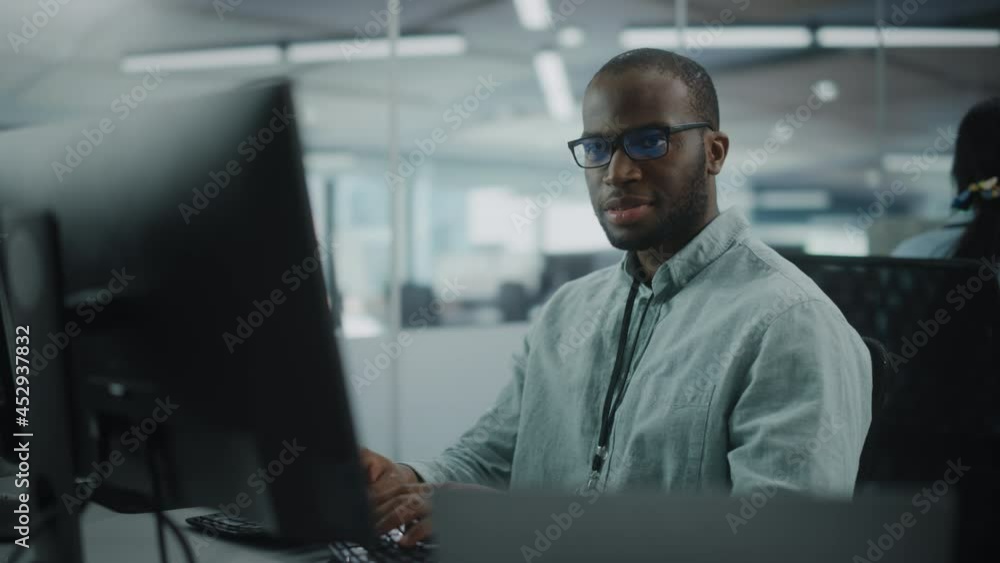 Fototapete Real Office: Professional Black IT Programmer Working on Desktop Computer. Male Website Developer and Software Engineer Developing App, Video Game. Progressive, Innovative and Inspirational Person