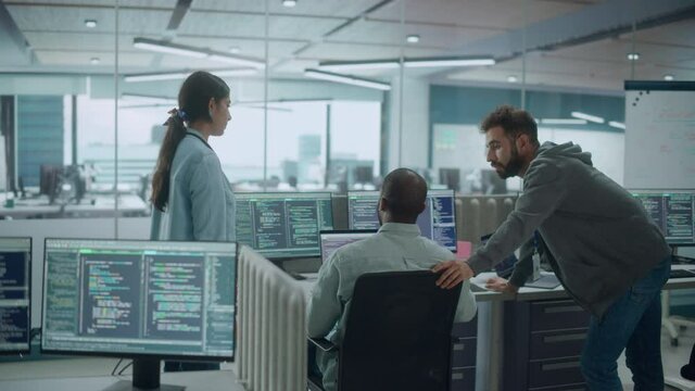 Diverse Group of Energetic Professionals Team Meeting in Modern Office: Brainstorming IT Programmers Use Computer, Talk Strategy, Discuss Analysis. Innovative Software Engineers Develop Ap. Static