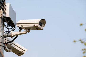 Closed-circuit camera attach on top of pole in park or public area for security reason with clear...