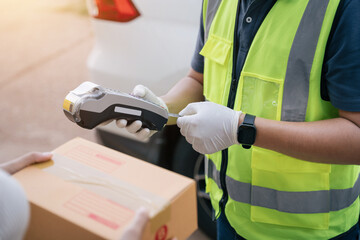 Close up hand of delivery man using a credit card reader while delivering products to customers at home, Cash on delivery concept with credit card.