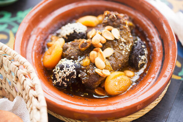 Moroccan lamb tajine with prunes, apricots, almonds and sesame seeds - obrazy, fototapety, plakaty