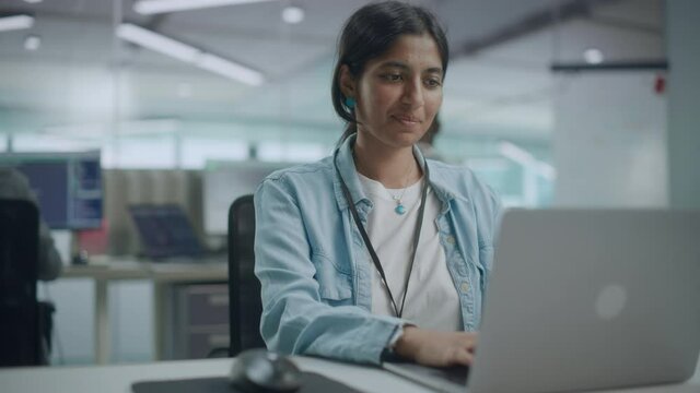 Diverse Office: Portrait of Beautiful Smiling Indian IT Programmer Working on Desktop Computer. Female Specialist Creating Innovative Software. Professional Engineer Develop Inspirational App