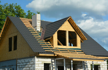 Attic roofing construction. A close-up of a wood roof framing over a vapor barrier and metal roof...
