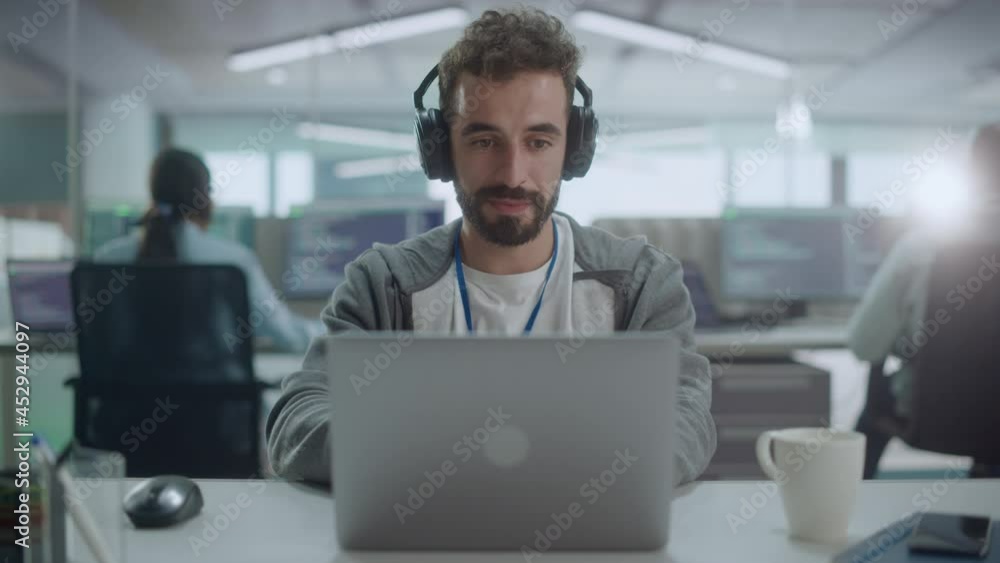Poster Office: Portrait of Smiling IT Programmer Wearing Headphones Working on Desktop Computer. Male Website Developer, Software Engineer Developing App, Video Game. Listening to Podcast, Music. Close-up