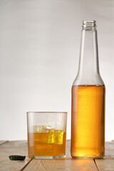 beer bottle with glass and ice on wooden boards