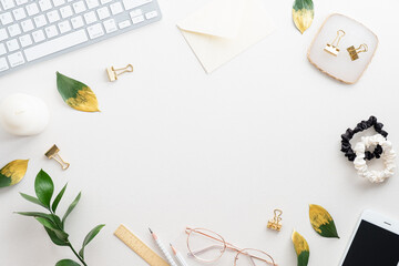 Elegant feminine workspace with keyboard, glasses and office supplies on white background. Flat lay, top view, copy space. Minimal style.