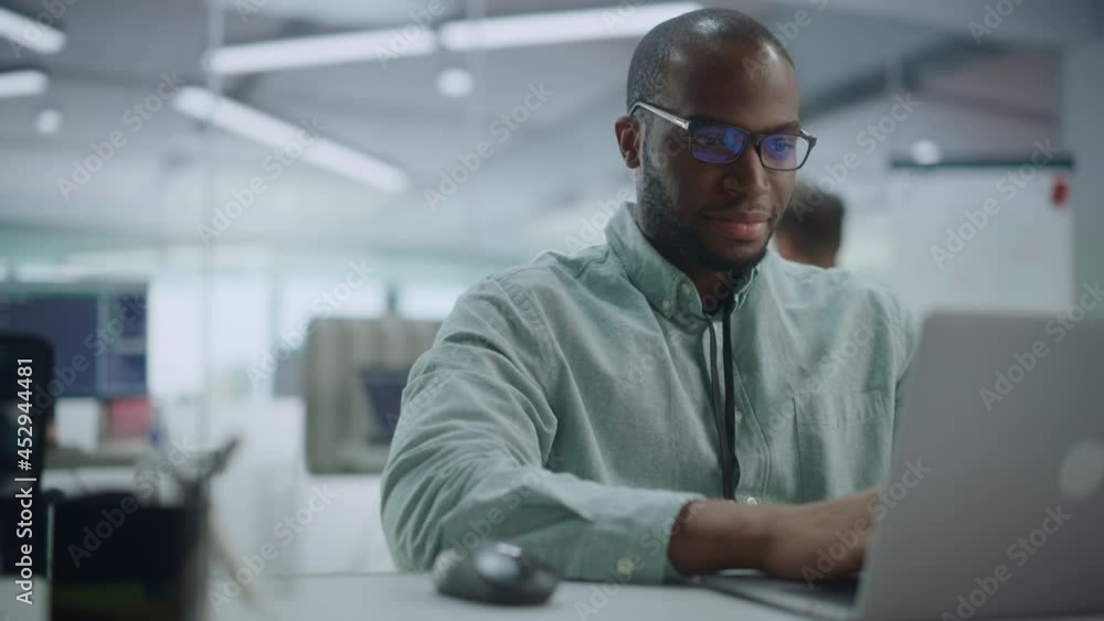Poster Modern Office: Portrait of Happy Black IT Programmer Working on Laptop Computer. Male Specialist Create Website, Software Engineer Develop App, Program, Video Game. Stress Free Inclusive Environment