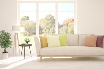 Stylish room in white color with sofa and autumn landscape in window. Scandinavian interior design. 3D illustration