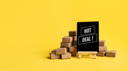 Online shopping with hot deal text with product box on yellow background.Business marketing