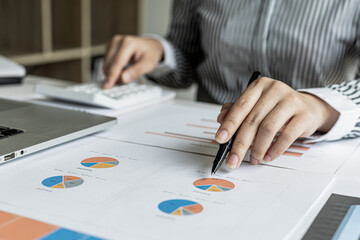 Businessman working in a private office, she is reviewing the company's financial documents sent from the finance department before he takes it to a meeting with a business partner. Financial concept.